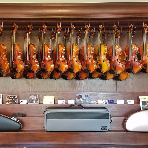 Sapp Violin Shop in Batavia, IL with several violins, violas and  accessories